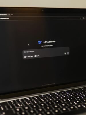 Image of a laptop showing an interactive AI interface with DeepSeek application.